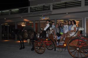 a group of people riding in a horse drawn carriage at Villa Anastasia in Keramoti