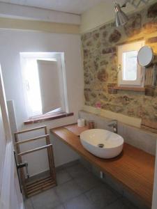 a bathroom with a sink on a wooden counter at Villa Lina B&B in San Felice Circeo