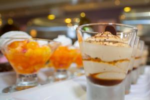 a row of desserts in glasses on a table at Hotel Park Makarska in Makarska
