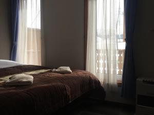 Postel nebo postele na pokoji v ubytování Alpine Wind