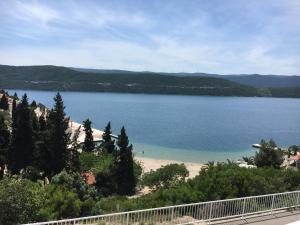 a large body of water with a sandy beach at Apartments Savić in Neum