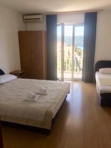 a bedroom with a bed with two towels on it at Apartments Savić in Neum