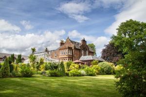 a large house with a lawn in front of it at Auchrannie Resort in Brodick