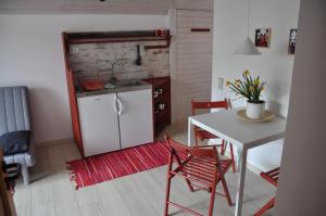 a small kitchen with a table and a sink at Ferienwohnung F. Keller in Kressbronn am Bodensee
