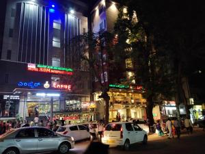 a busy city street at night with cars parked at ABM Express Inn in Bangalore