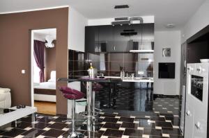a kitchen with a black and white checkered floor at Vila El Barco in Veliko Gradište +51 photos