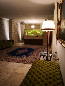 a living room with a couch and a table with a lamp at Hotel Boutique Il Castellino Relais in Vieste