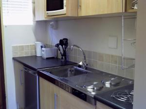 a kitchen with a sink and a counter top at Kozmos in Clarens