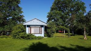 a small house in the middle of a green yard at Silna Nowa 2 in Pszczew