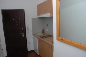 a kitchen with a black door and a kitchen counter at Vila El Barco in Veliko Gradište