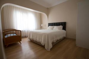 a bedroom with a large bed and a window at Yeni Apart Hotel in Buyukada