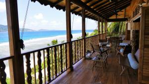 a balcony of a resort with a view of the ocean at Lakaz An Bwa in La Digue