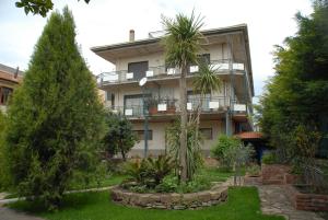 an apartment building with trees in front of it at Ai Tre Parchi Bed And Bike in Randazzo