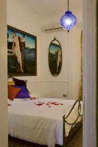 1 dormitorio con 1 cama con una pintura en la pared en B&B Lido Liberty - "L'abbraccio di Klimt", en Lido di Ostia