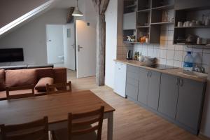 a kitchen and living room with a table and a couch at CEN Wydminy in Wydminy