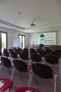 a room with a bunch of chairs and a screen at Residenza Del Parco in Vigevano