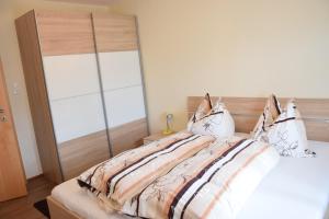 a bedroom with a large bed with a wooden headboard at Appartement Stichauner in Tschöran