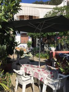 a table and two chairs and an umbrella at Holiday Home Gionny & Mary in Taormina