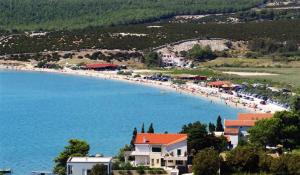 a beach with a bunch of people on it at Apartments Loncar-near Zrće beach in Novalja