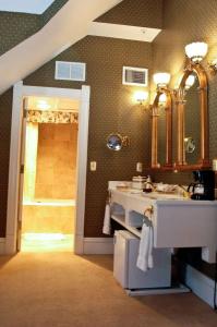 a bathroom with a sink and a mirror at Cliff House at Pikes Peak in Manitou Springs