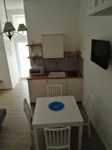 a kitchen with a table with a blue plate on it at Casa Mina in Monopoli