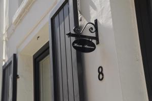 una señal de entrada a la casa en el lateral de un edificio en Huize Amoras en Amberes