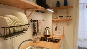 a small kitchen with a sink and a stove at House SoleSiculo in Siracusa