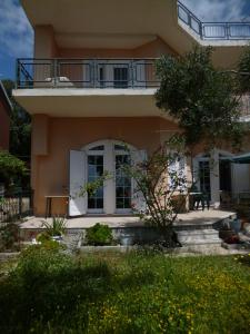 a large house with a balcony on top of it at Deskas House. Two Floor Apartment With Excellent View in Parga