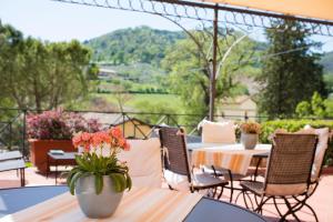 a patio with tables and chairs with a view at Albergo Villa Cristina in Spoleto