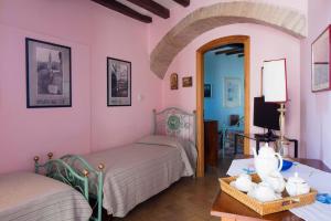 a bedroom with two beds and a table and a mirror at Albergo Villa Cristina in Spoleto