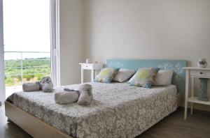 מיטה או מיטות בחדר ב-Fiora Villas
