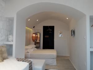 a white room with two beds and a couch at Villa Faros in Aliko Beach