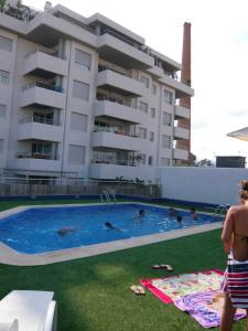 a group of people in a swimming pool in front of a building at La Loma in Águilas