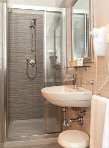 a bathroom with a shower with a sink and a toilet at Hotel Nazionale in Lido di Jesolo