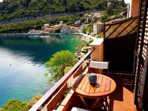 a balcony with a table and a view of the water at Apartments Anica in Sobra