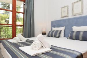 a hotel room with two towels on a bed at Maison La Mer in Agia Paraskevi