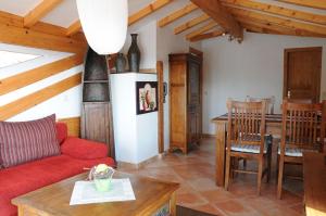 a living room with a red couch and a table at Pension Bergel in Sankt Martin
