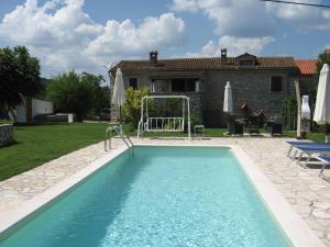 a swimming pool in a yard with a house at Villa Elda in Motovun