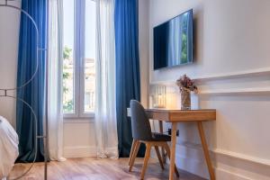 Łóżko lub łóżka w pokoju w obiekcie Livemalaga Centro Suites