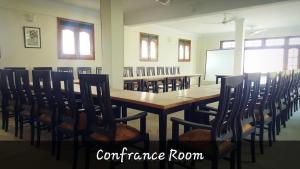 a classroom with a table and chairs and a whiteboard at Stargaze Hotel & Apartment in Abbottābād