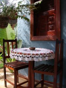 a table and two chairs and a table with a tablecloth at Pousada Bangalô in Jericoacoara +45 photos