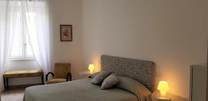 a bedroom with a bed with two lamps on it at EnzHouse in Rome
