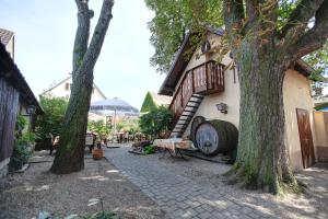 a building with a staircase next to a tree at Gasthaus zum Hirschen in Oberrimsingen