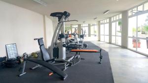 a gym with several tread machines in a room at Silver Beach Delux Apartment in Byala