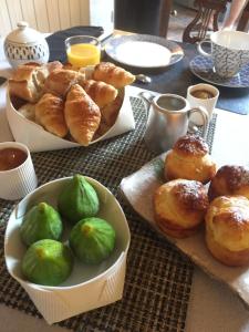 a table with two plates of pastries and a bowl of bread at Chambres d'hôtes La Borderie du Gô près de La Rochelle - Nieul in Nieul-sur-Mer +44 photos