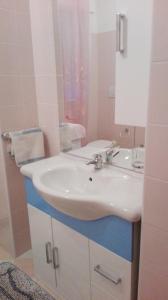 a bathroom with a white sink and a mirror at Porzione di villetta in Silvi Paese