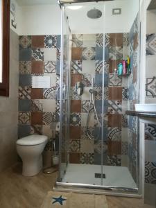 a bathroom with a shower and a toilet at Montorfano Suite in Rovato