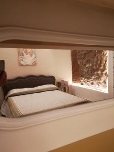 a person taking a picture of a bed in a room at Montorfano Suite in Rovato
