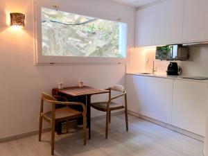 a small kitchen with a table and chairs in a room at Smart Studio Cadaqués Sa Guarda in Cadaqués