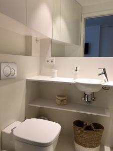 a white bathroom with a toilet and a sink at Smart Studio Cadaqués Sa Guarda in Cadaqués